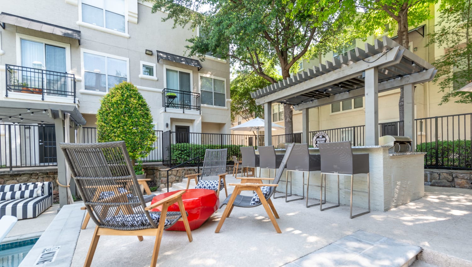 Poolside lounge area and grilling pavilion at 75 West in Dallas, Texas