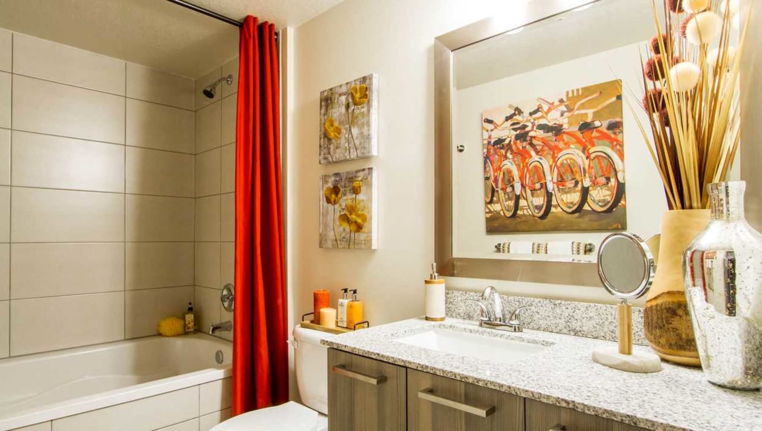Bathroom with granite countertops, designer cabinetry, and a tiled shower/tub at Luzano in Pompano Beach, Florida