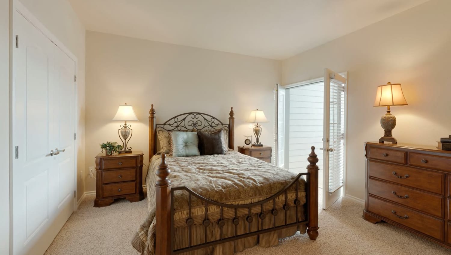 Bedroom with doors to balcony at The Preserve at Greenway Park in Casper, Wyoming