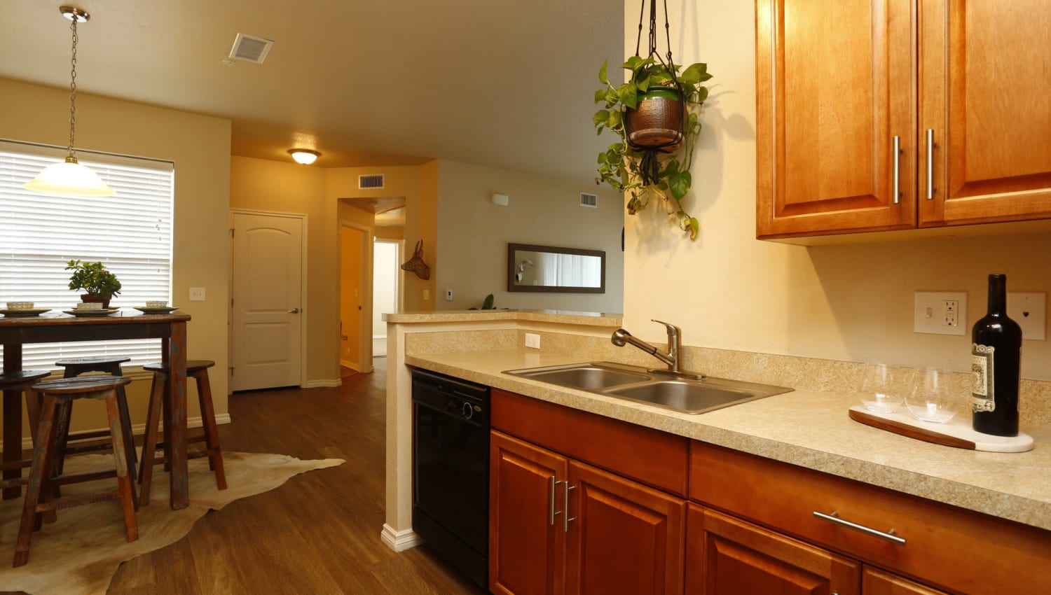 Kitchen with wood flooring and black appliances at The Preserve at Greenway Park in Casper, Wyoming