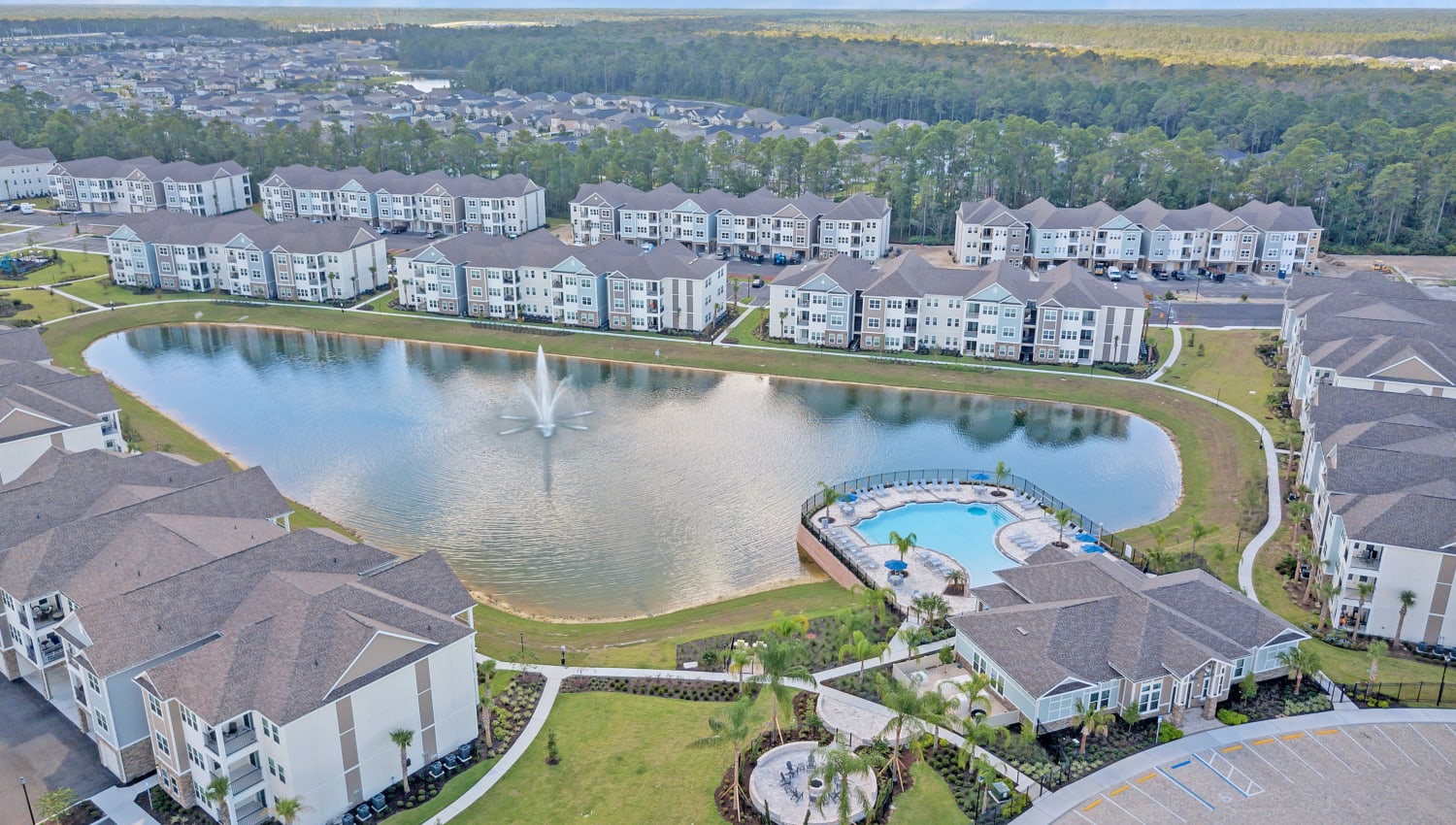 Aerial view of the community with pool and lake at The Carlton at Bartram Park in Jacksonville, Florida