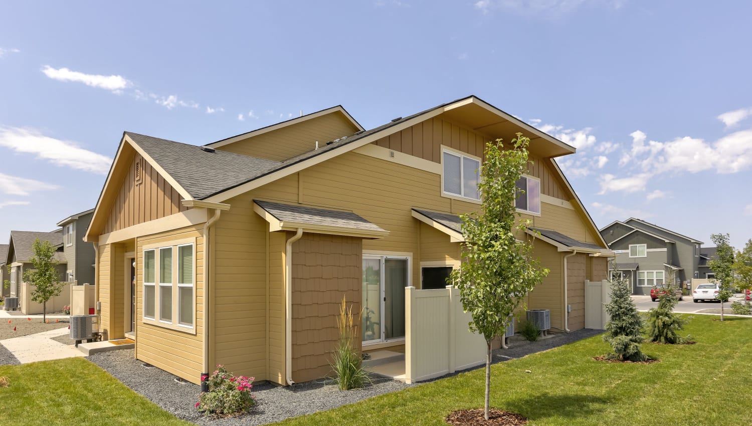Townhome with green lawn at Cedar Park & Canyon Falls Townhomes in Twin Falls, Idaho