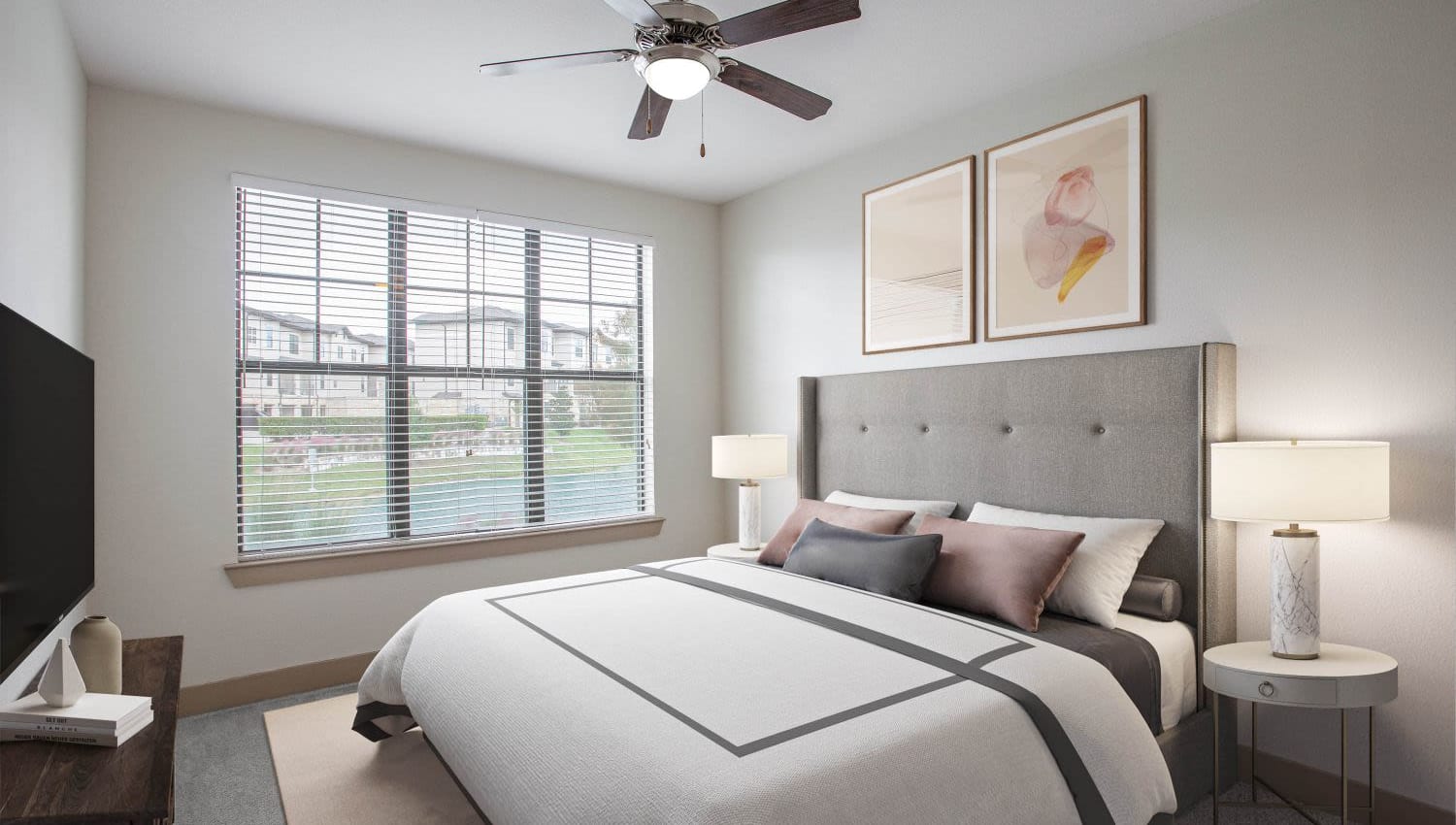 Model guest bedroom with bedside lamps at Olympus Falcon Landing in Katy, Texas