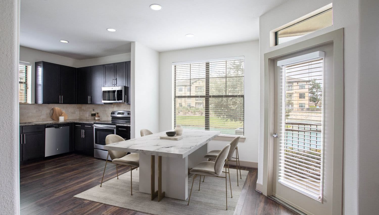 Model kitchen with dining nook and plenty of natural light at Olympus Falcon Landing in Katy, Texas