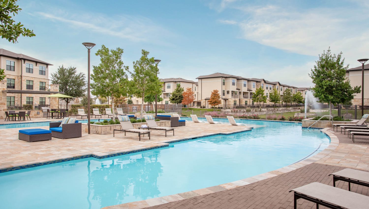 Large outdoor pool on a sunny day at Olympus Falcon Landing in Katy, Texas