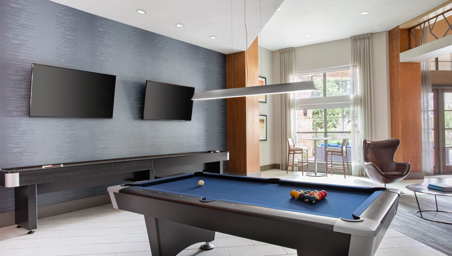 Pool table and shuffleboard for resident use at Olympus Falcon Landing in Katy, Texas