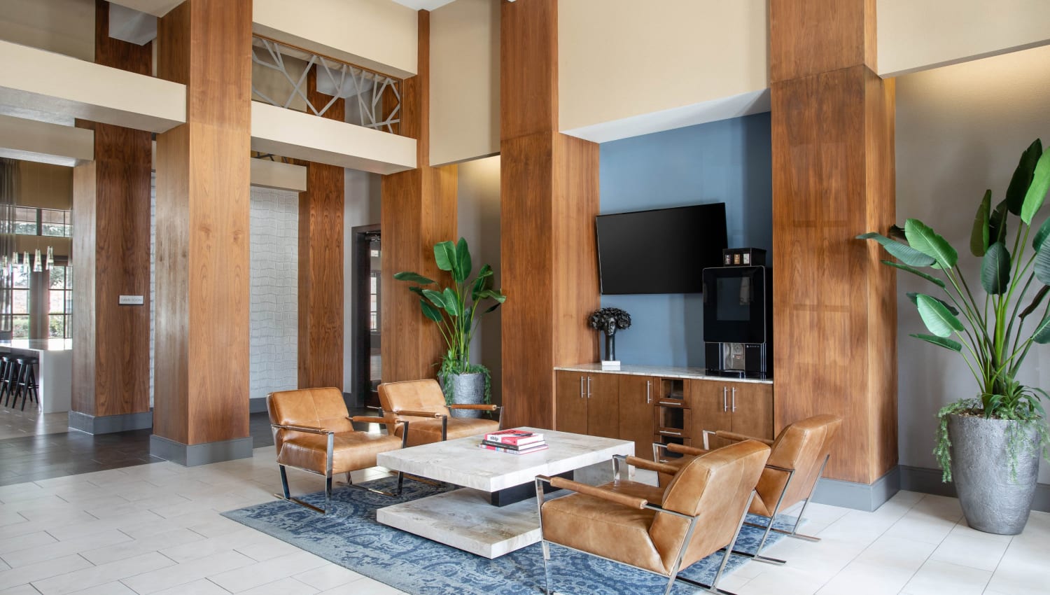 Lounge area with TV and leather chairs at Olympus Falcon Landing in Katy, Texas