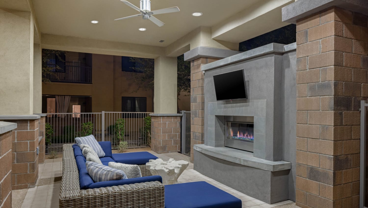 Outdoor couches with a TV and fireplace at Cadia Crossing in Gilbert, Arizona