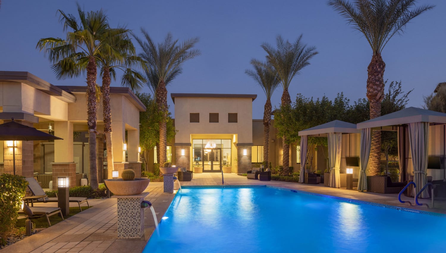 View of the outdoor pool during dusk at Cadia Crossing in Gilbert, Arizona