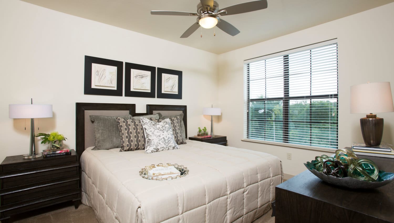 Well decorated bedroom with ceiling fan at Olympus at Memorial in Houston, Texas