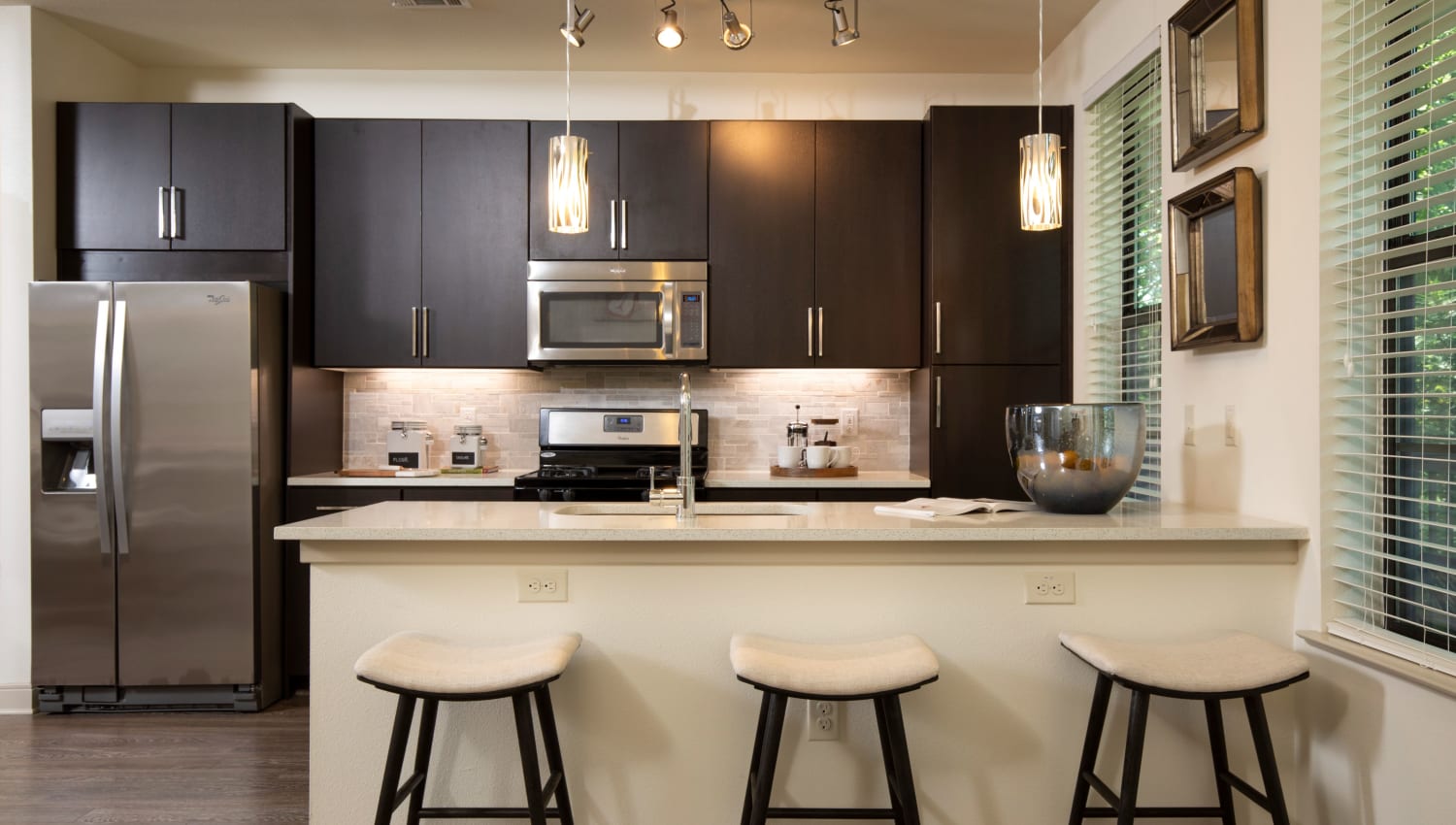 Larges and spacious kitchen with three barstools at Olympus at Memorial in Houston, Texas
