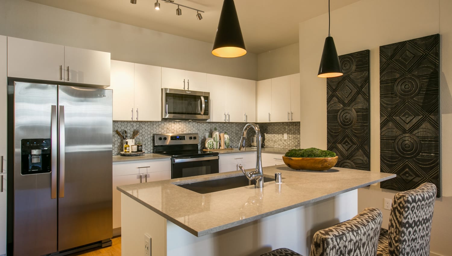 Modern kitchen with stainless-steel appliances and island at Olympus de Santa Fe, Santa Fe, New Mexico 