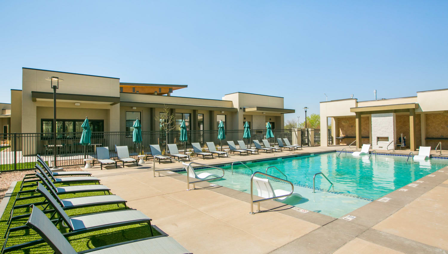 Resort style pool with lounge chairs at Olympus de Santa Fe, Santa Fe, New Mexico