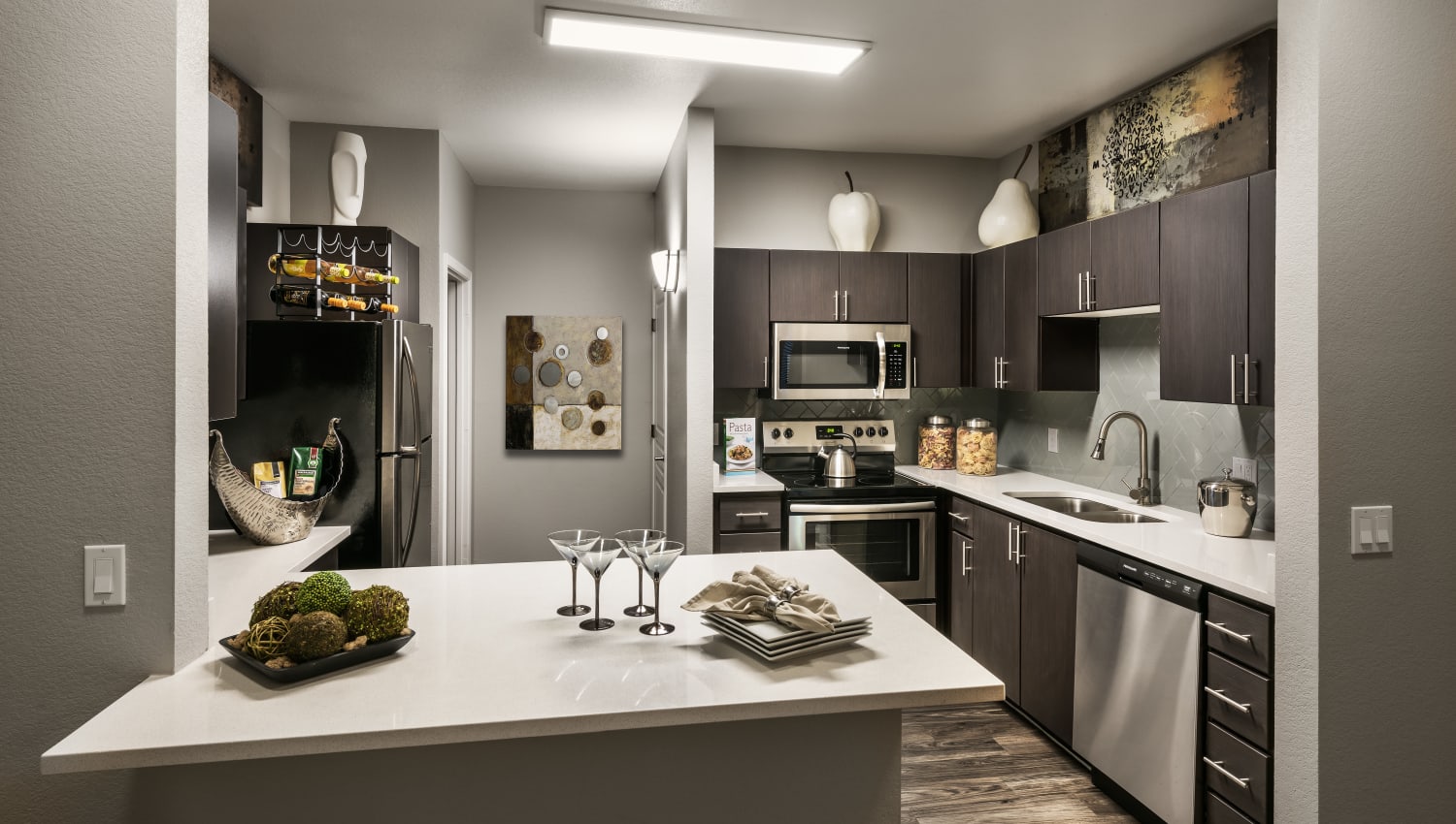 Gourmet kitchen with stainless-steel appliances at Avenue 25 in Phoenix, Arizona