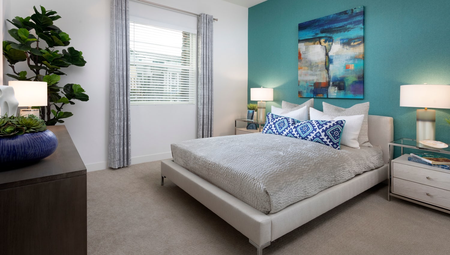 Bedroom with blue accents at The Residences at Escaya in Chula Vista, California