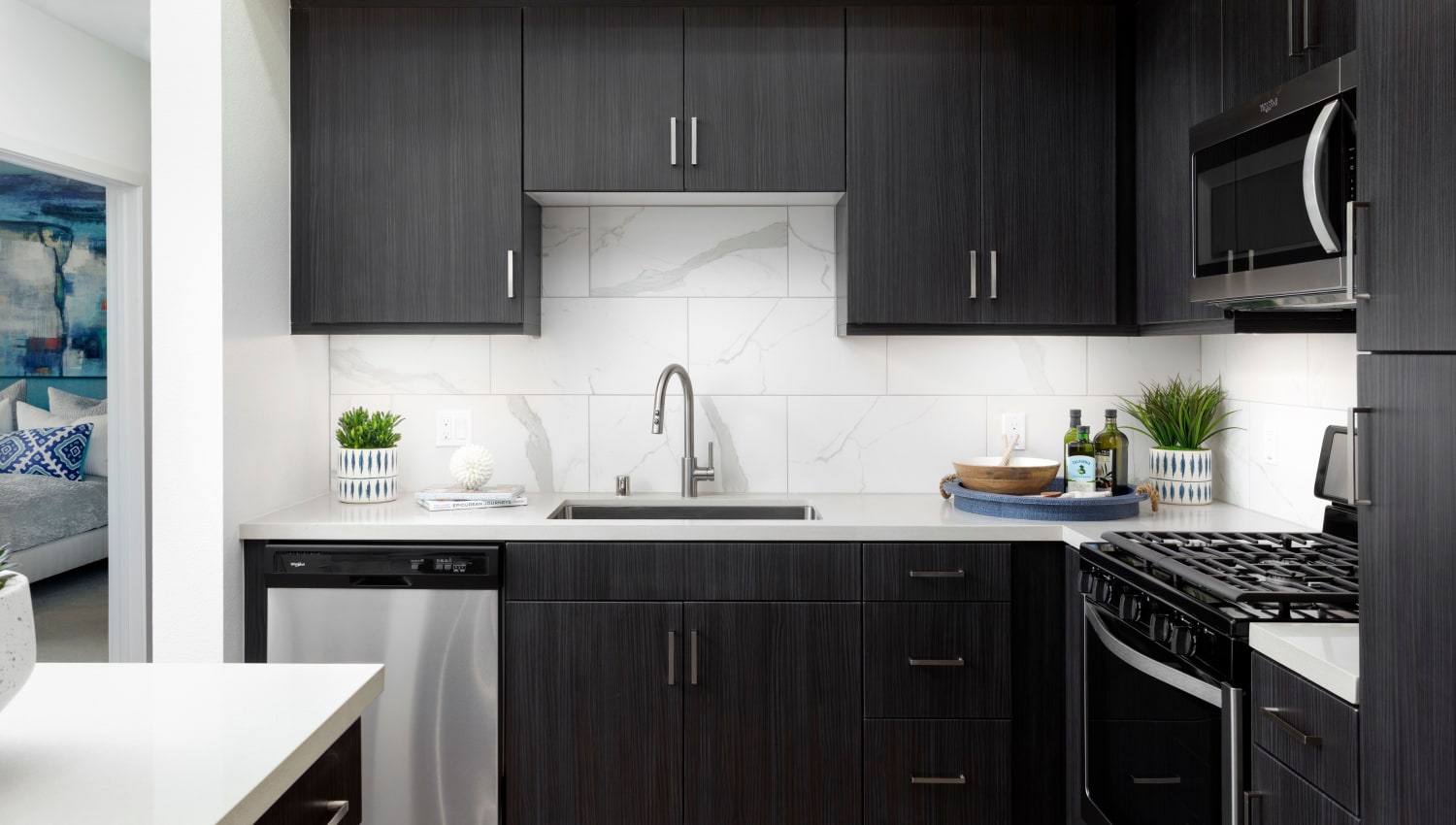Model kitchen with black cabinetry at The Residences at Escaya in Chula Vista, California