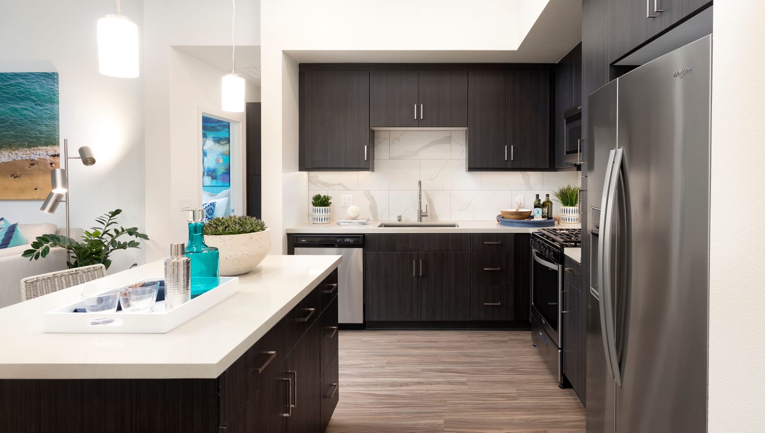Model kitchen with island and black cabinetry at The Residences at Escaya in Chula Vista, California