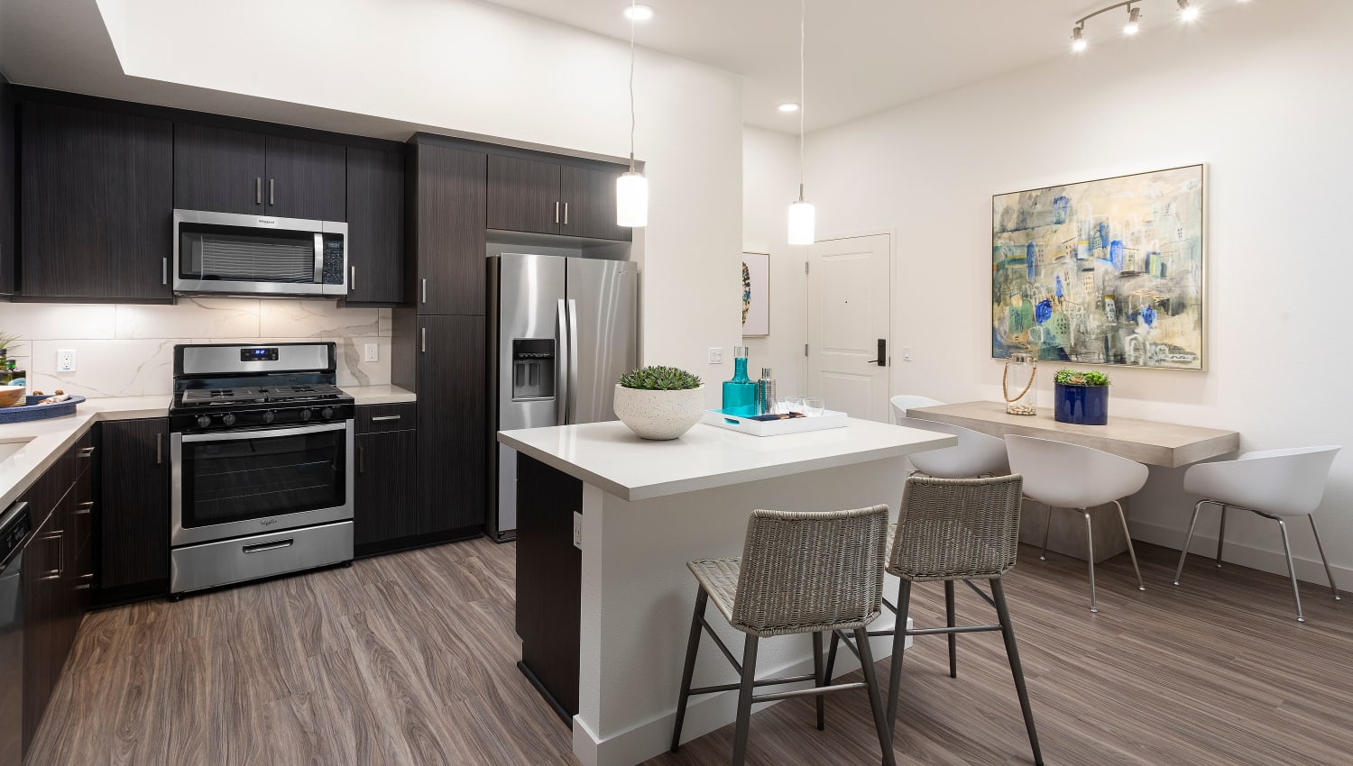 Model kitchen leading into dining space at The Residences at Escaya in Chula Vista, California