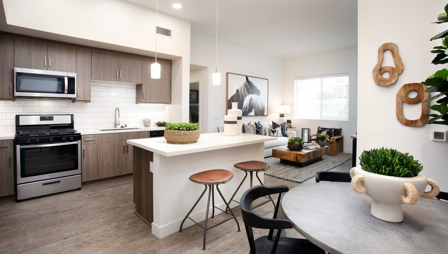 Modern kitchen space with bar seating at The Residences at Escaya in Chula Vista, California