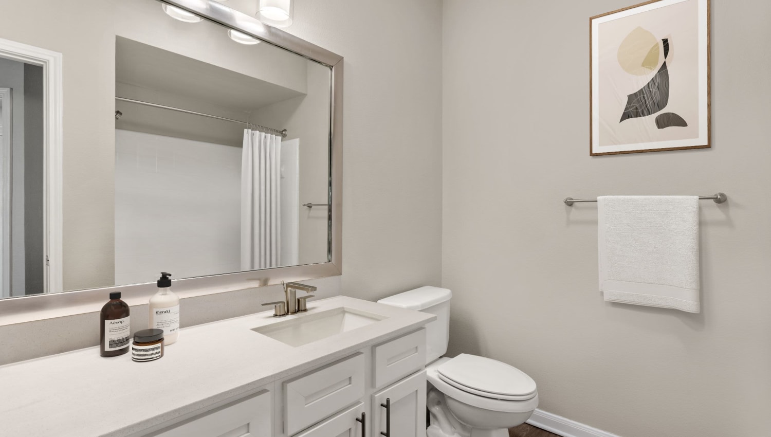 Luxury bathroom with white cabinetry at Olympus Las Colinas in Irving, Texas