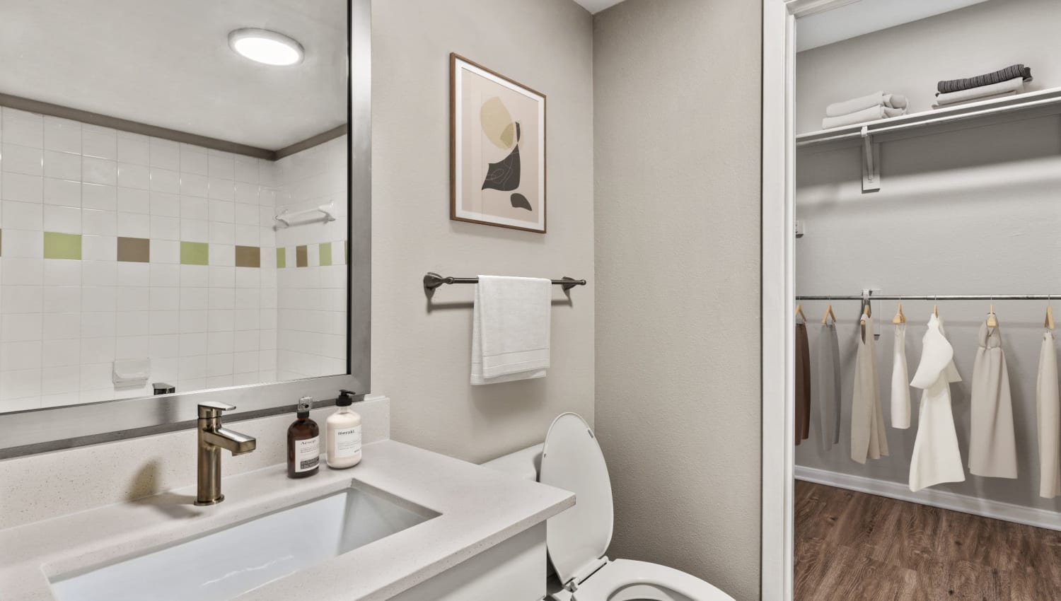 Bathroom with attached walk-in closet at Olympus Boulevard in Frisco, Texas