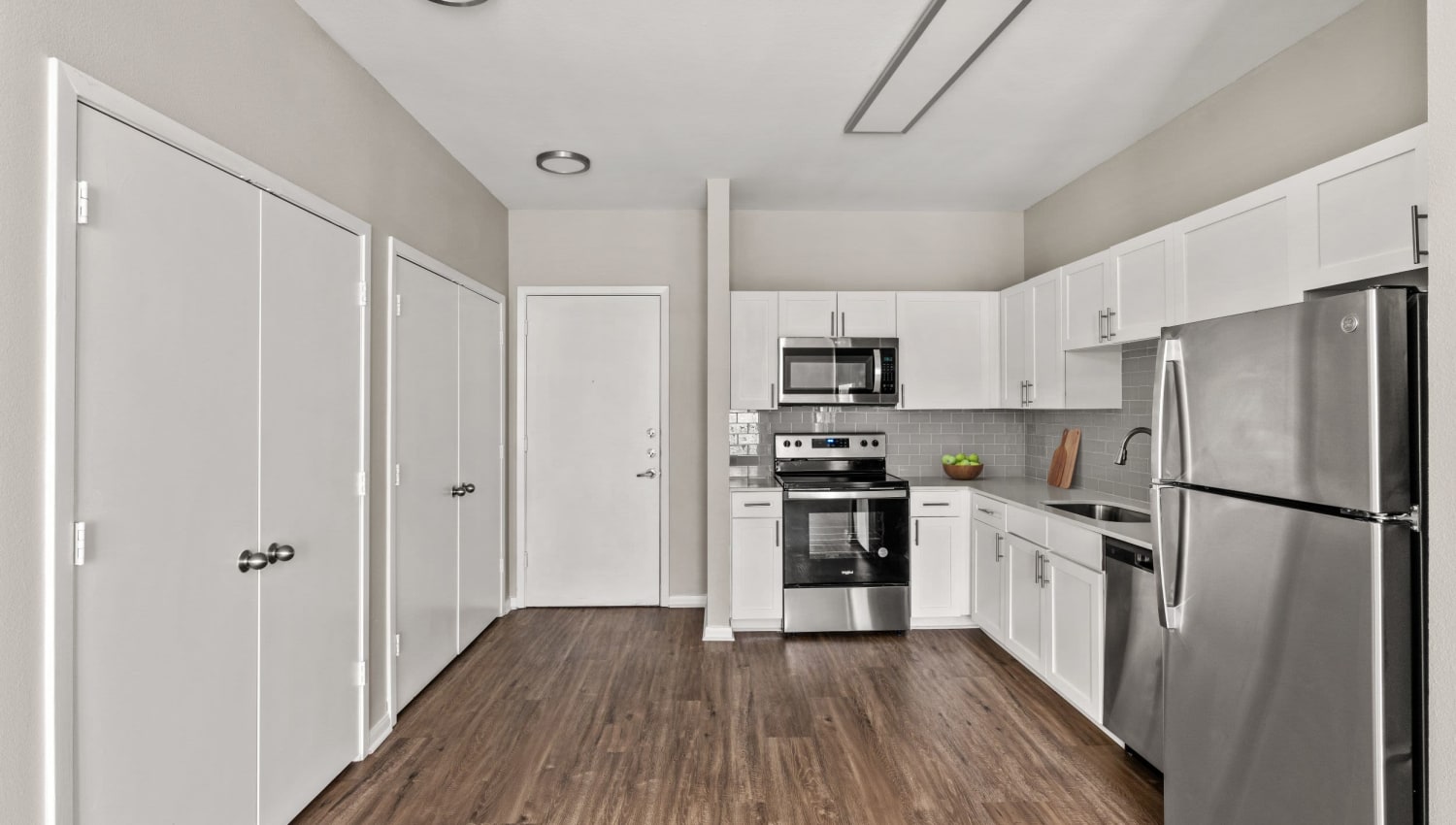Spacious model kitchen with hardwood flooring at Olympus Boulevard in Frisco, Texas