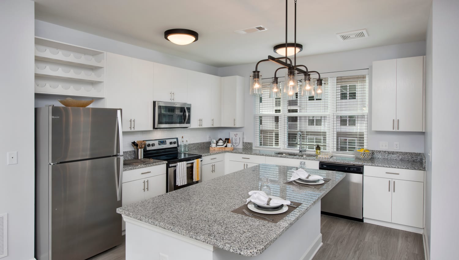 Kitchen with stainless-steel appliances and granite countertops at Capital Crest at Godley Station in Savannah, Georgia