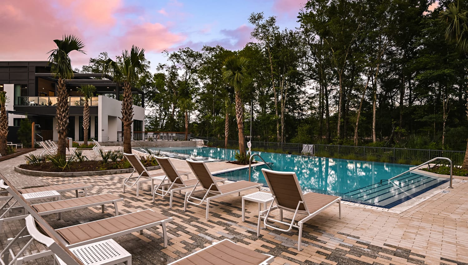 Chaise lounge chairs by the pool at Olympus Preserve at Town Center in Jacksonville, Florida