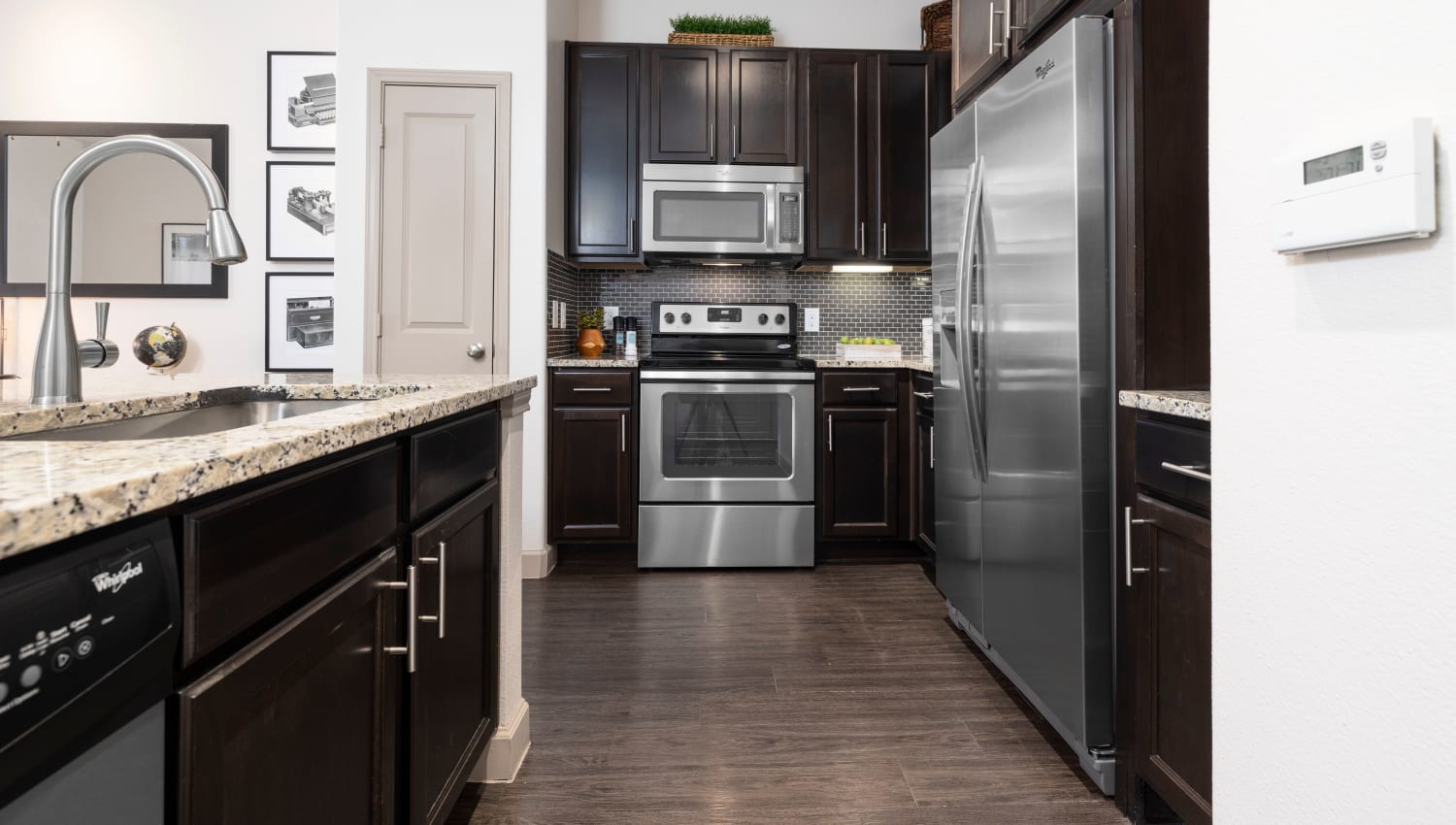 Kitchen with modern appliances at Olympus Auburn Lakes in Spring, Texas