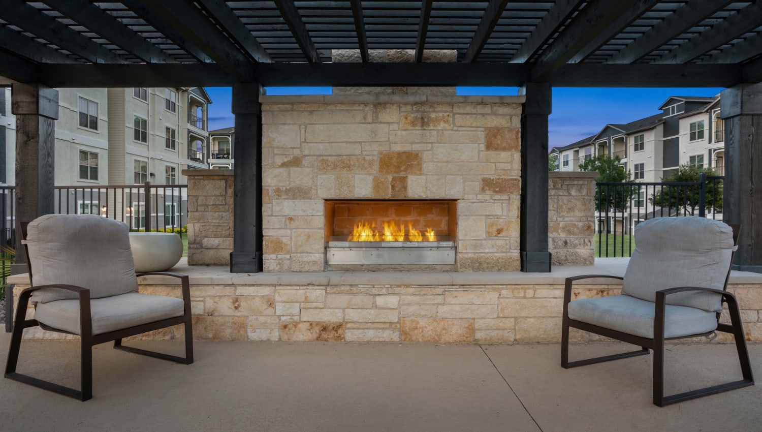 Outdoor fireplace area at Olympus Woodbridge in Sachse, Texas