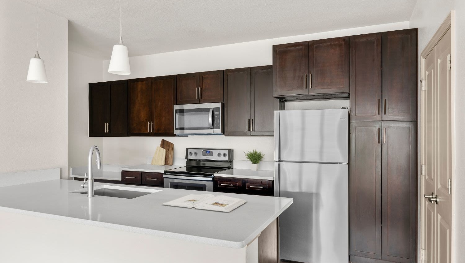 Resident's kitchen with table island at Lakeline at Bartram Park in Jacksonville, Florida