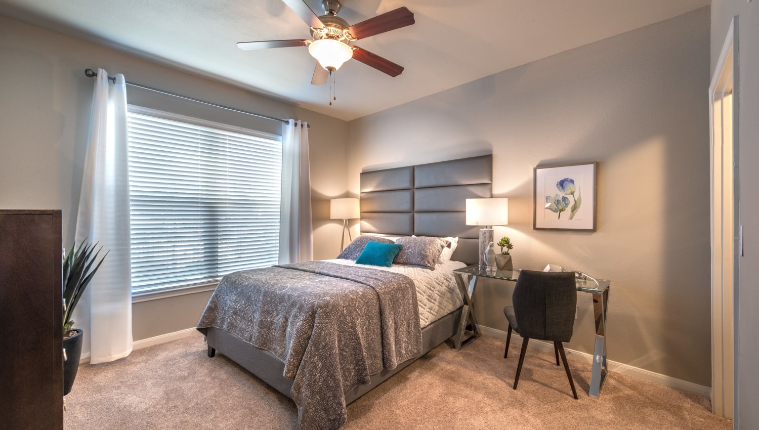 Bedroom with carpet and large window  at Olympus Las Colinas