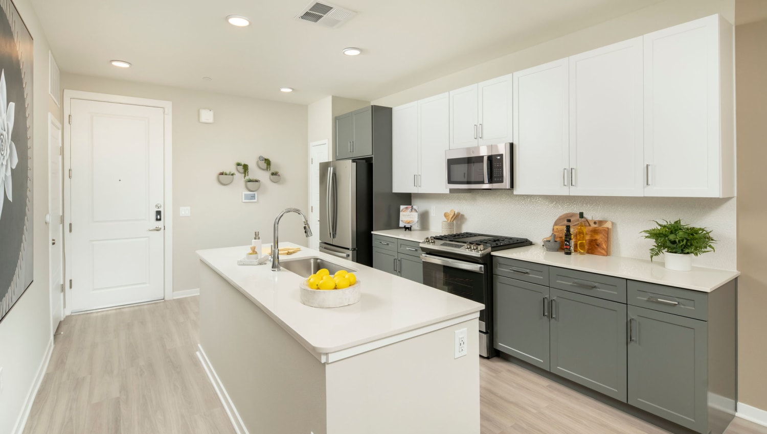 Kitchen with wood-style flooring at Olympus Chandler at the Park in Chandler, Arizona