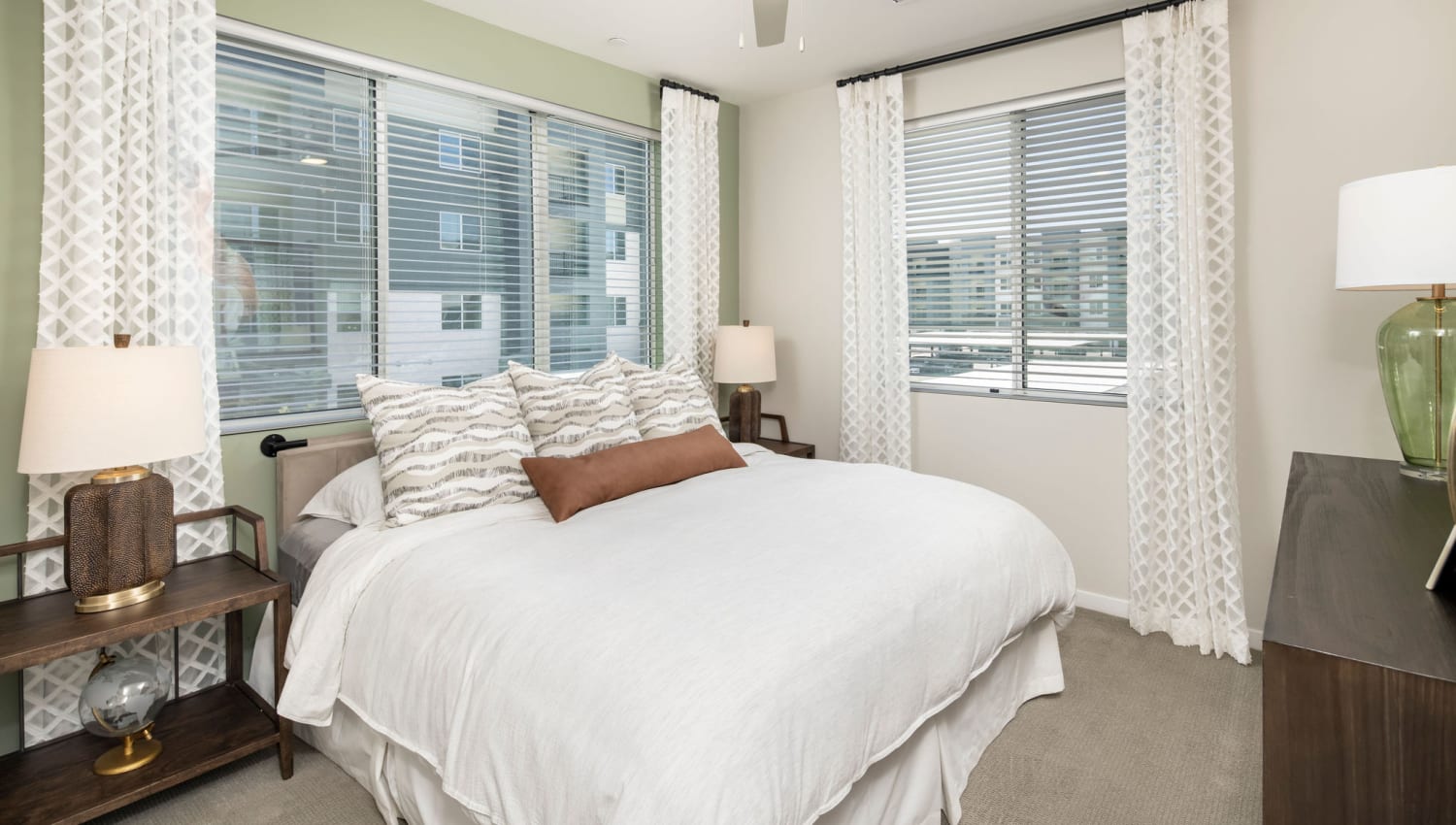 Bedroom with multiple large windows at Olympus Chandler at the Park in Chandler, Arizona