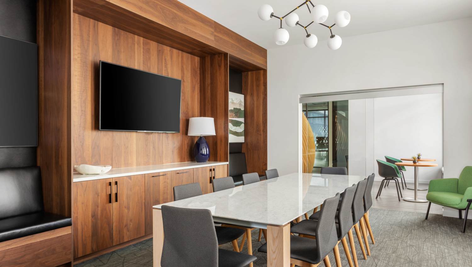 Large meeting table and TV in the resident lounge at 207 East in Edgewood, WashingtonCl