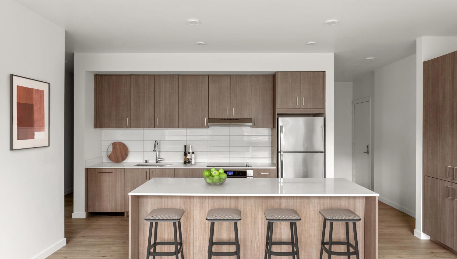 Kitchen with an island and counter stools at 207 East in Edgewood, Washington