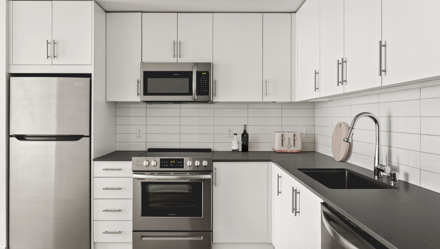 Modern kitchen with stainless-steel appliances at Helm in Everett, Washington
