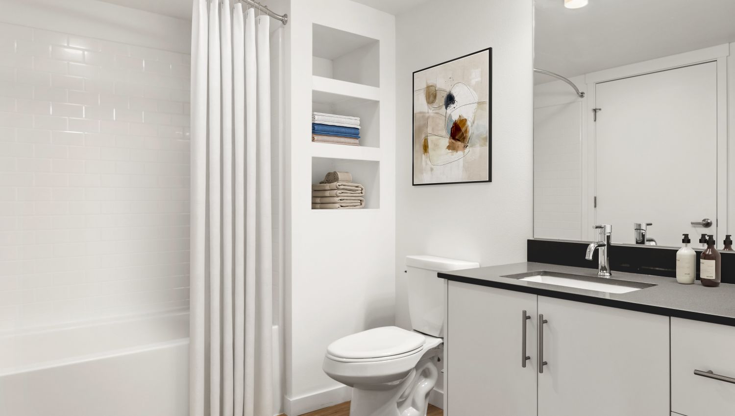 Bathroom with white cabinetry at Helm in Everett, Washington