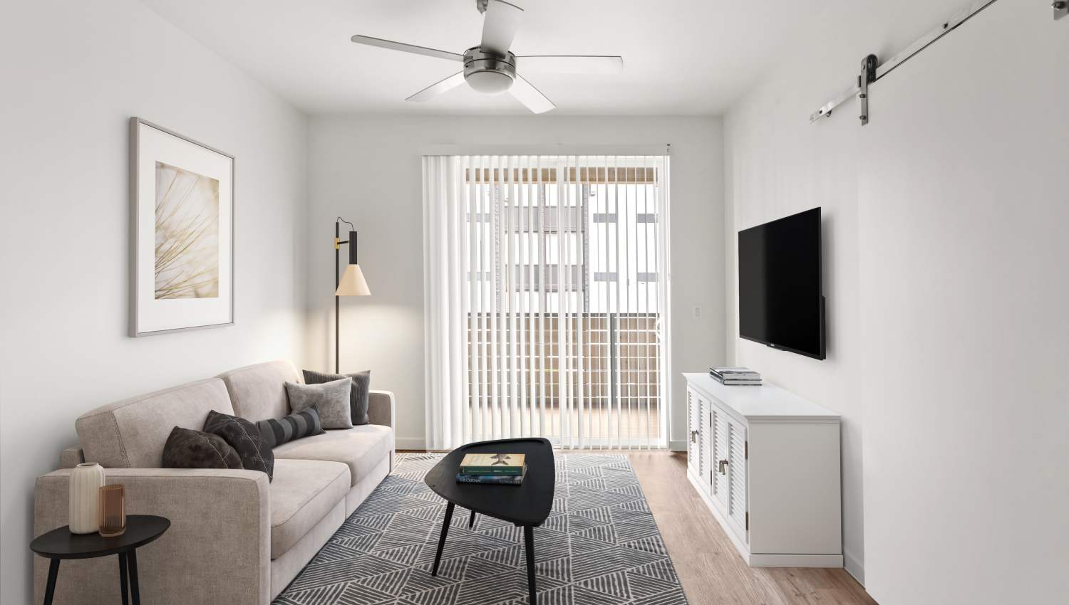 Living room with a ceiling fan at Helm in Everett, Washington