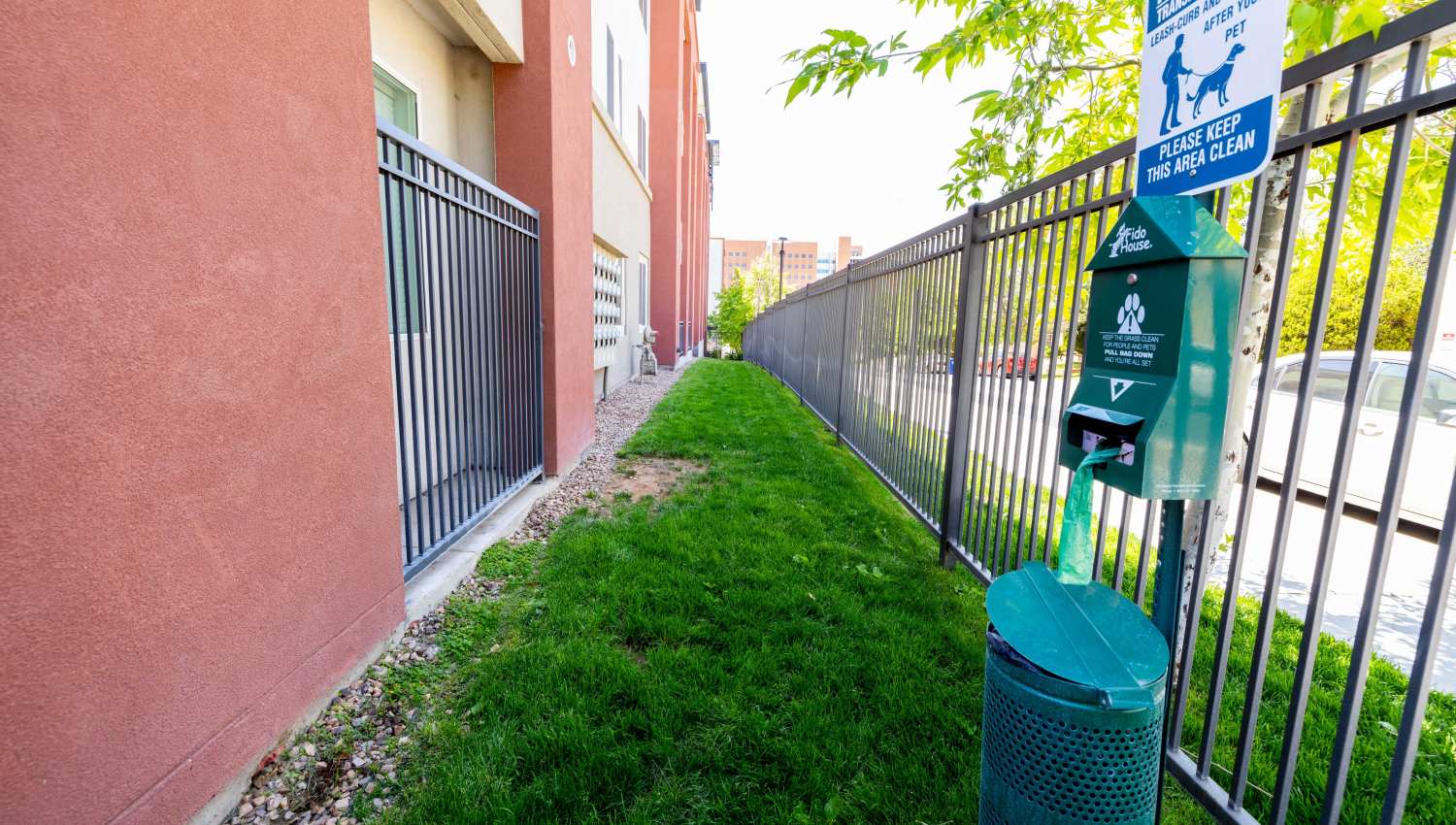 A fenced area with a green trash can  at Olympus Highlands North in Albuquerque, New Mexico