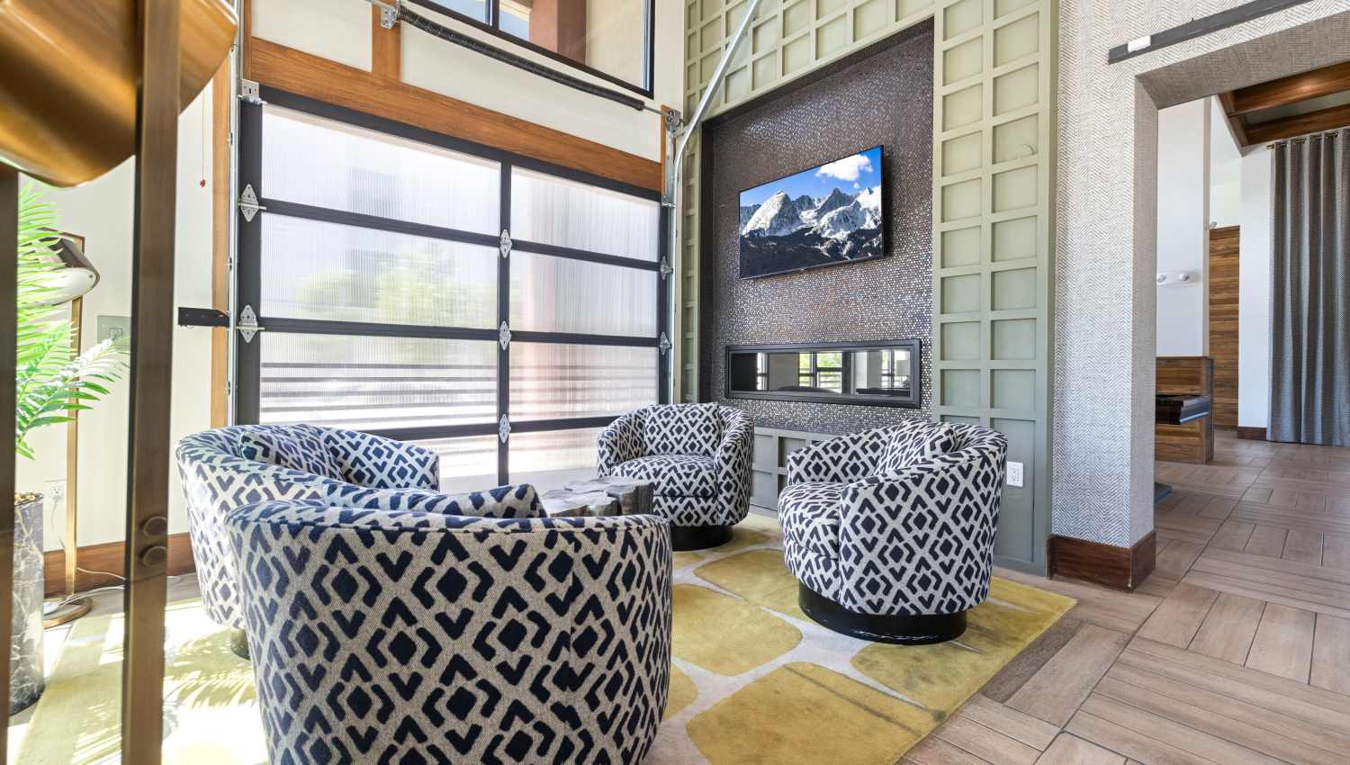 A clubhouse room with chairs and a tv at Olympus Highlands North in Albuquerque, New Mexico