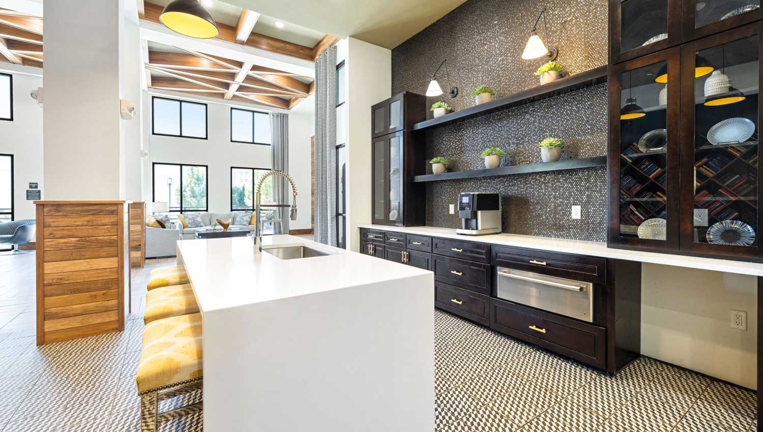 A kitchen with a white island and a black and white tile floor at Olympus Highlands North in Albuquerque, New Mexico