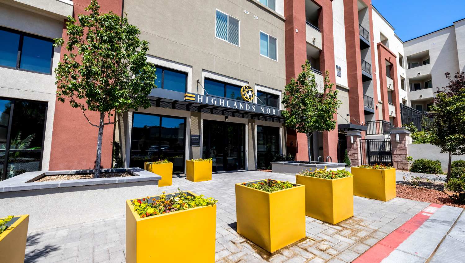 A building with yellow planters at Olympus Highlands North in Albuquerque, New Mexico
