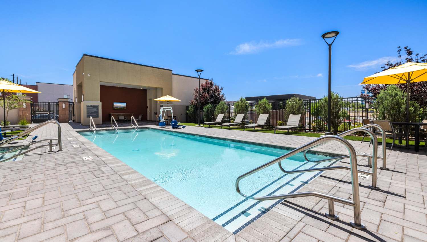 A swimming pool with a building in the background  at Olympus Highlands North in Albuquerque, New Mexico