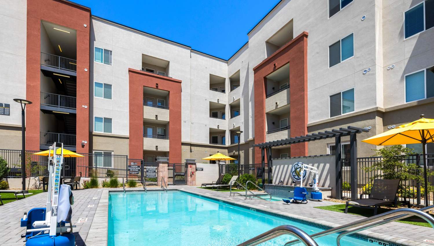 A pool in front of a building at Olympus Highlands North in Albuquerque, New Mexico