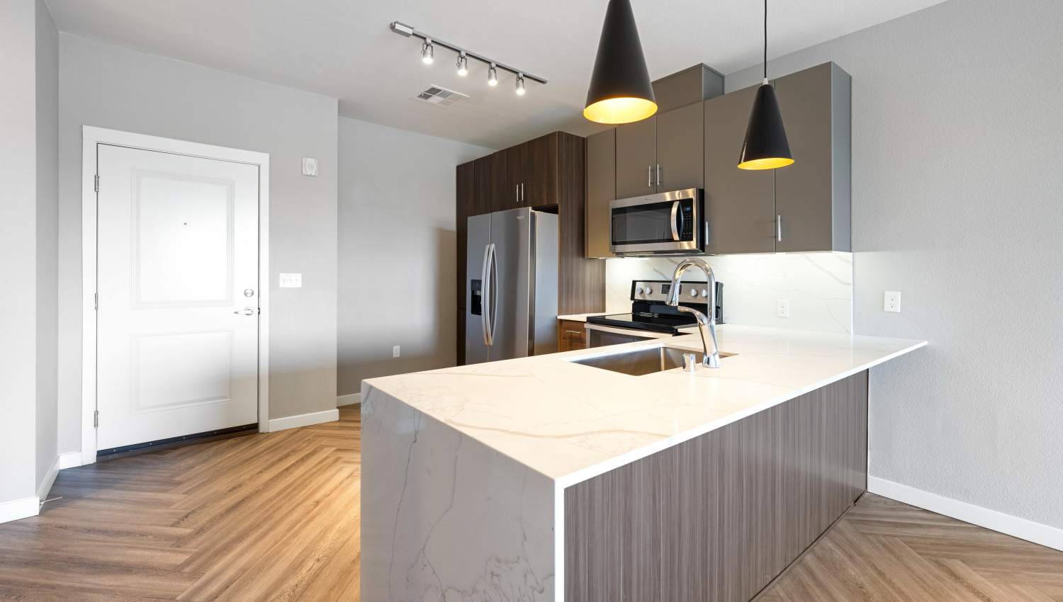 A kitchen with a white countertop at Olympus Alameda in Albuquerque, New Mexico