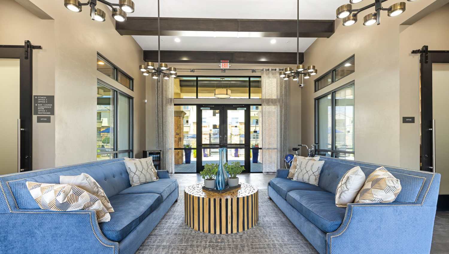 Clubhouse lobby with blue couches and a coffee table at Olympus Alameda in Albuquerque, New Mexico