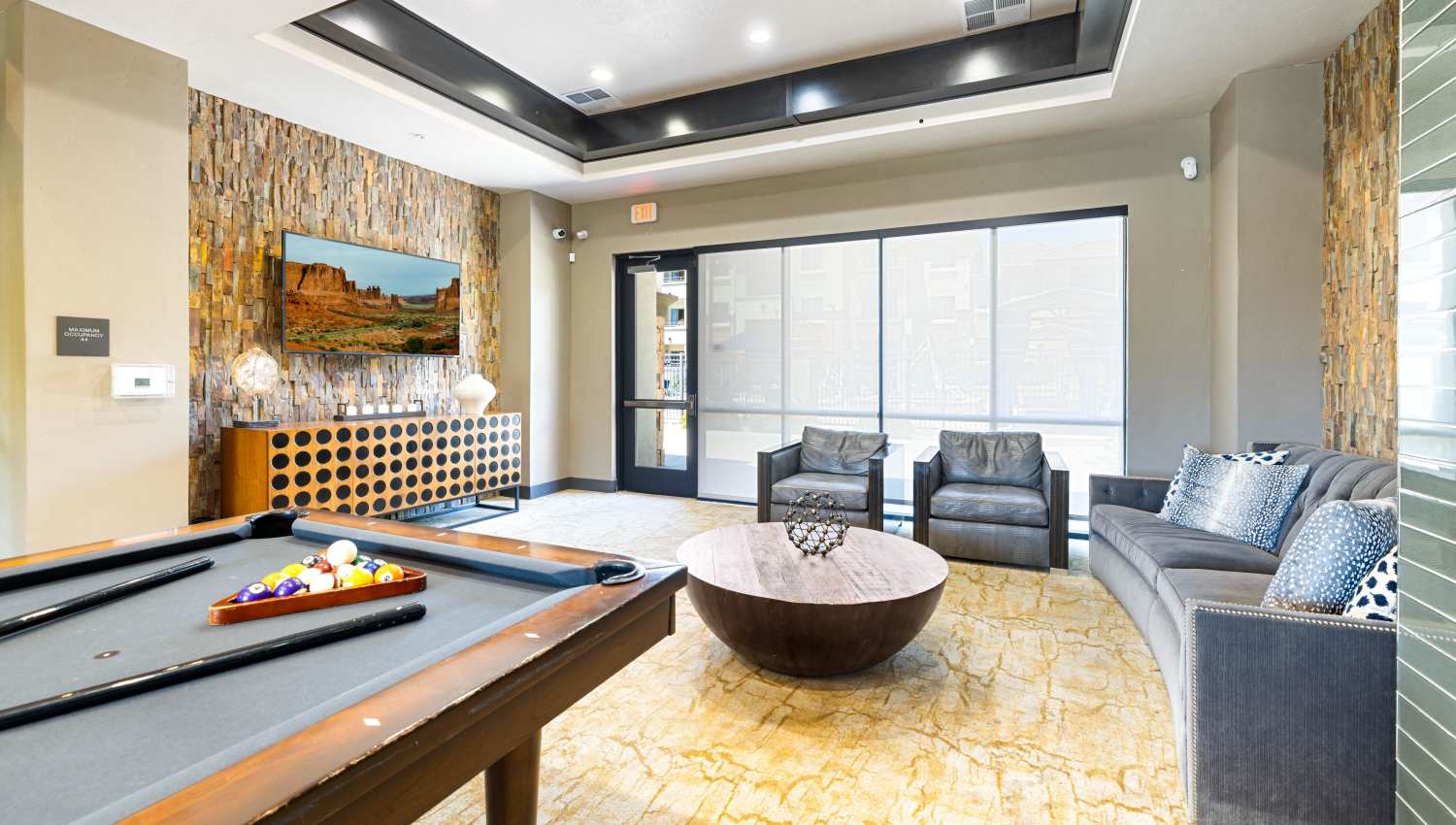 Billiard table in a room with couches at Olympus Alameda in Albuquerque, New Mexico
