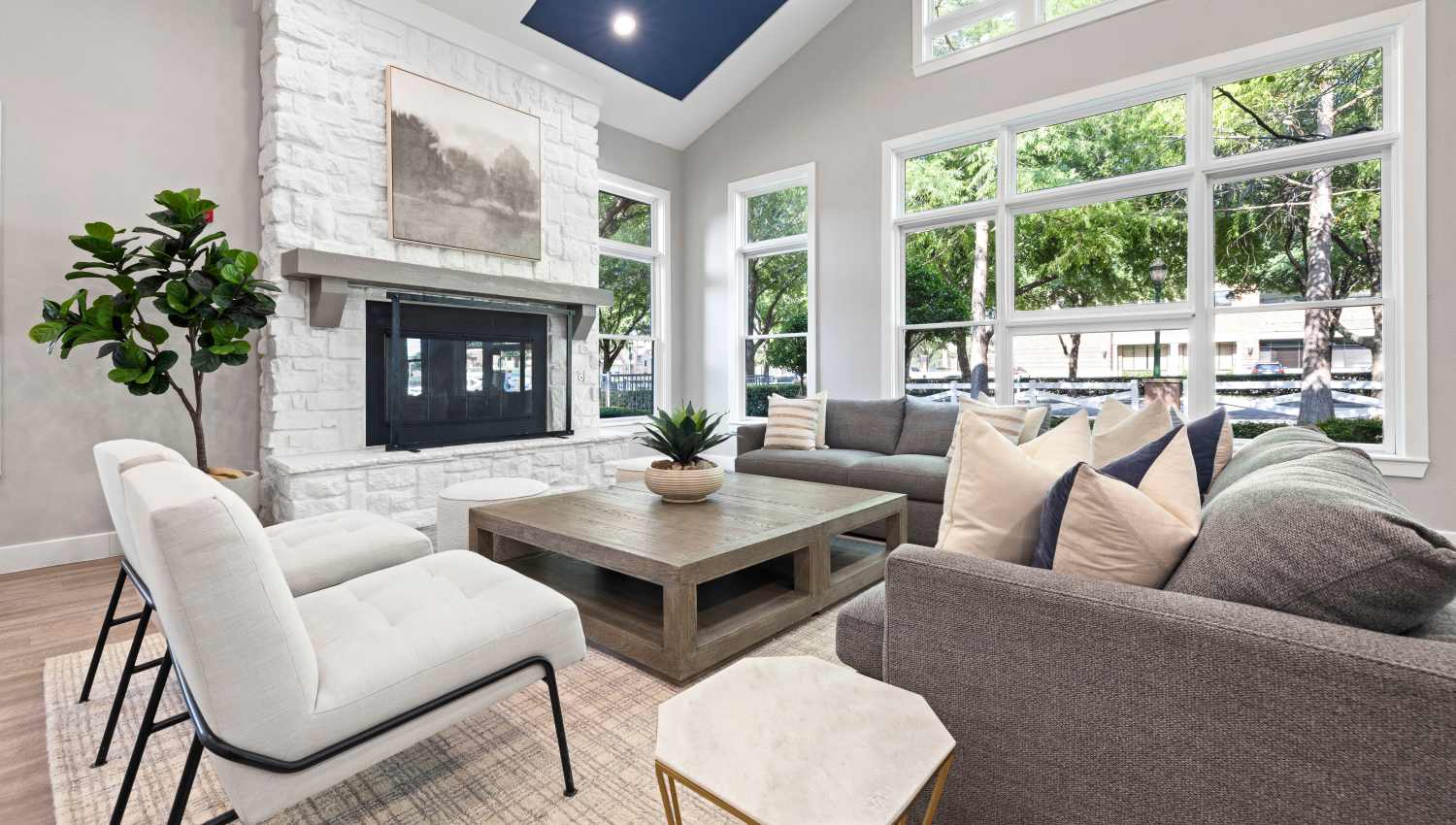 Clubhouse living  area with a fireplace and couches at Olympus Town Center in Keller, Texas