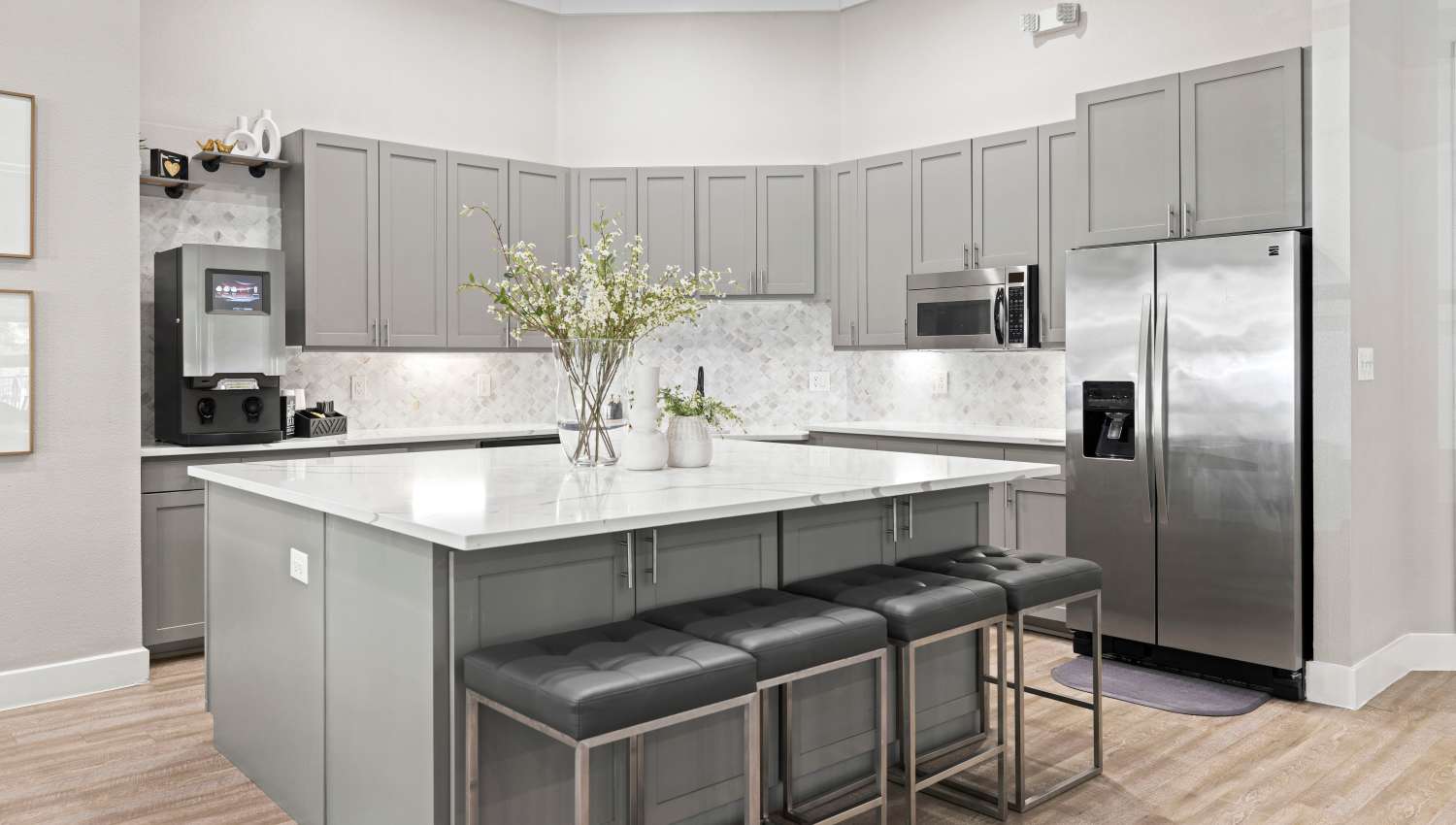 A kitchen with a large island with appliances  at Olympus Town Center in Keller, Texas